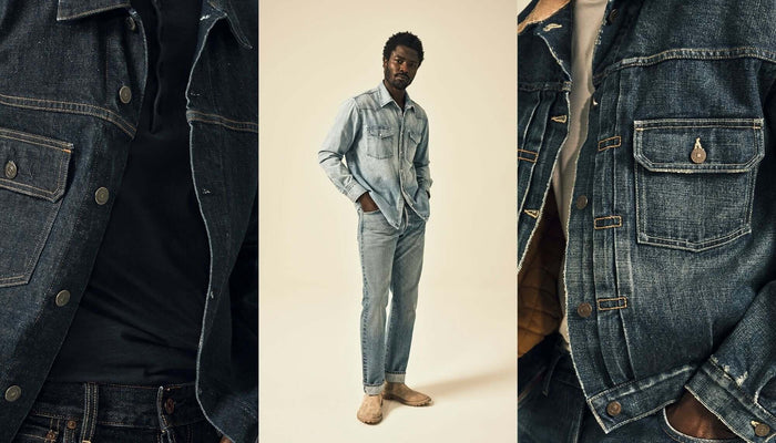 A stack of jeans beside a man wearing a pair of jeans 